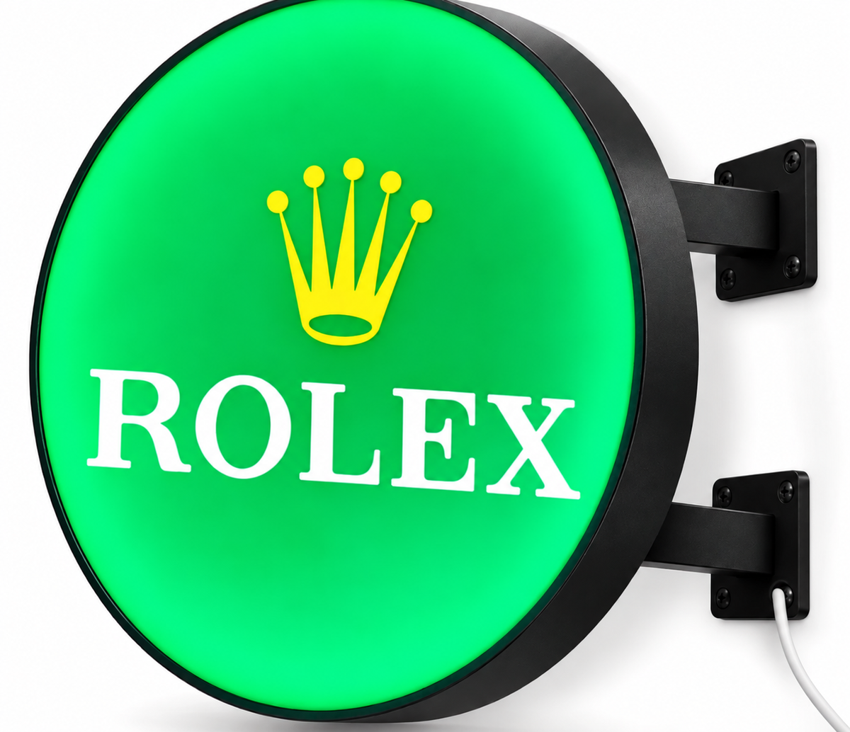 Green round double-sided light box with black wall brackets and a white cord