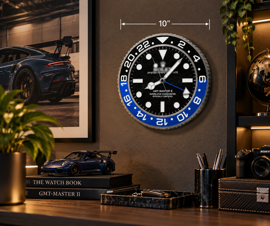 Black and blue bezel 10 inch wall clock on a dark wall above a desk