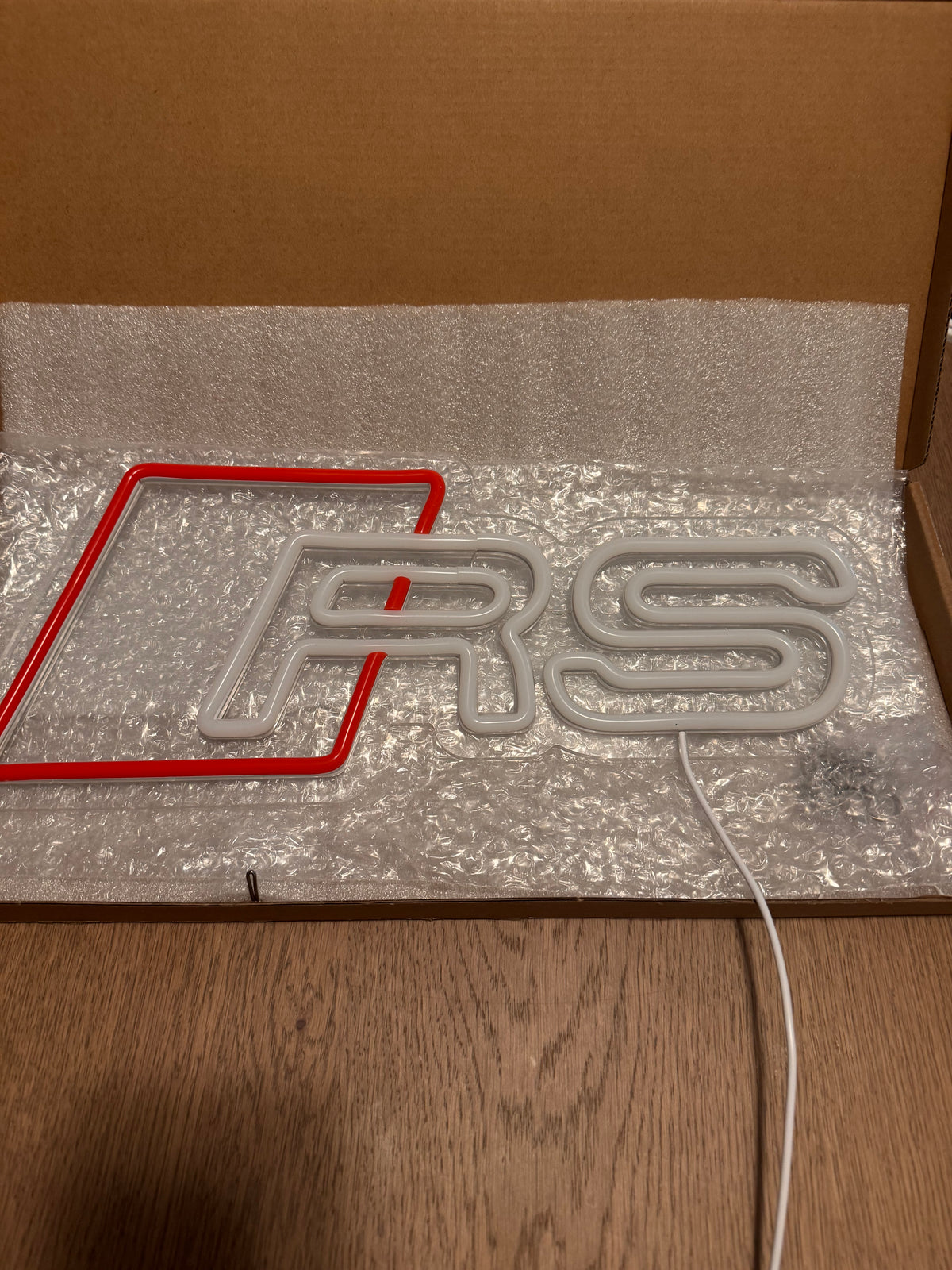 Audi RS LED neon sign switched off, showing the clear acrylic backing