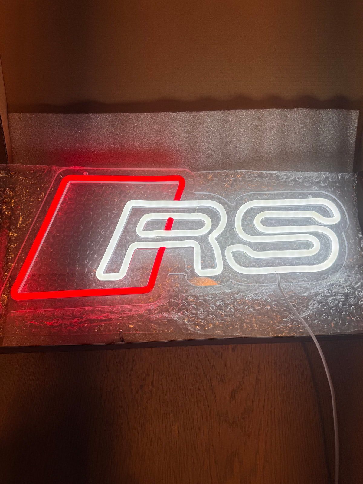 Audi RS LED neon sign lit red and white on its packaging