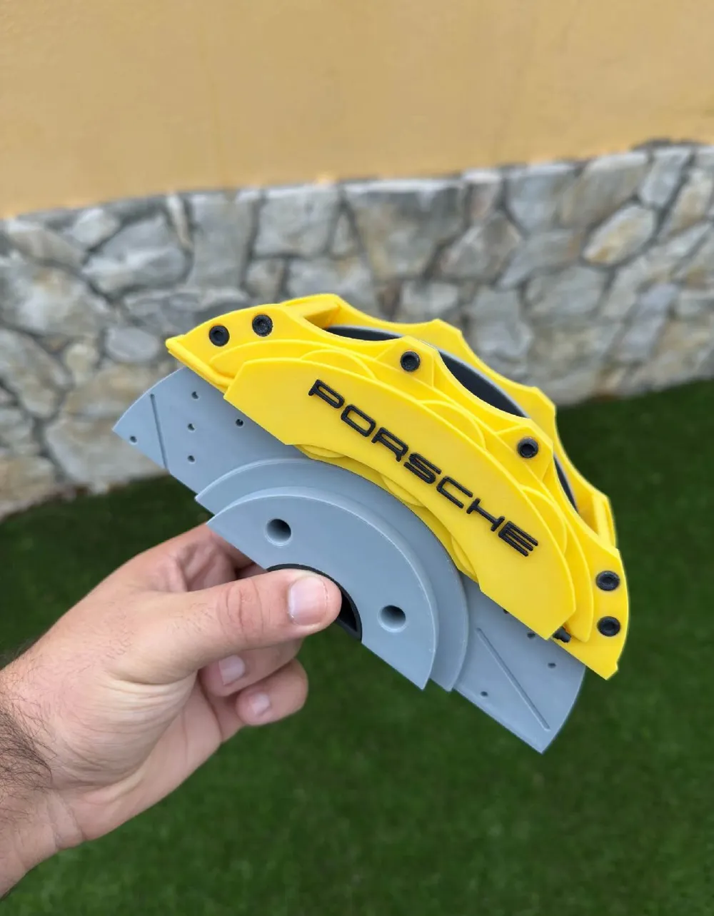 Porsche yellow brake caliper pen holder side view