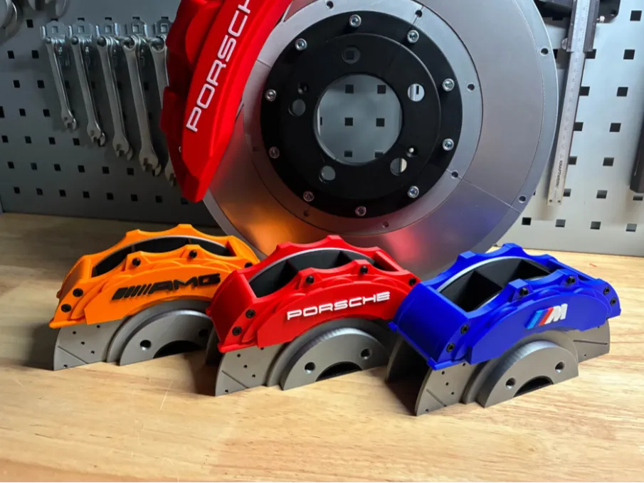 Custom brake caliper pen holders in AMG orange, Porsche red and BMW M blue