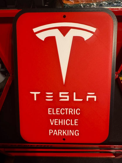 White letters, logo and outline, red background, Tesla EV parking sign in a red tool chest