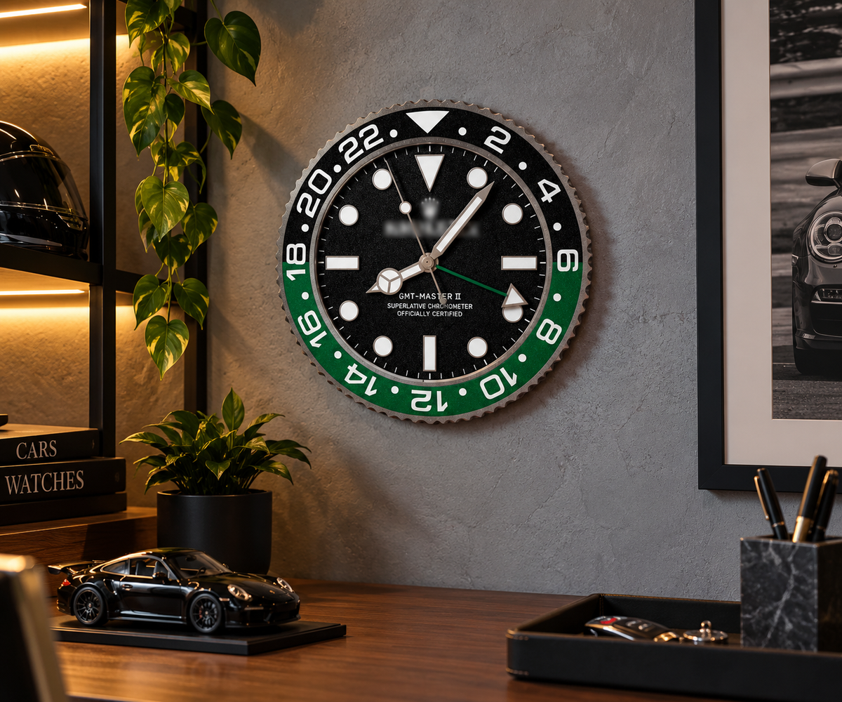 Black and green bezel wall clock on a gray wall above a desk