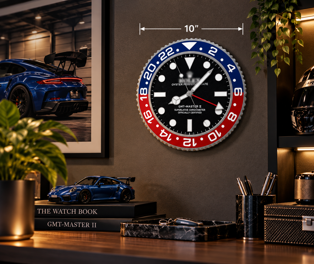 Blue and red bezel 10 inch wall clock on a dark wall above a desk